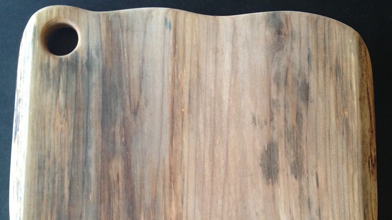 Fix A Warped Wood Cutting Board With A Damp Cloth And An Iron